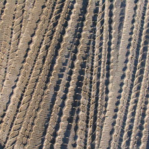 Tire Tracks in Dirty Sand