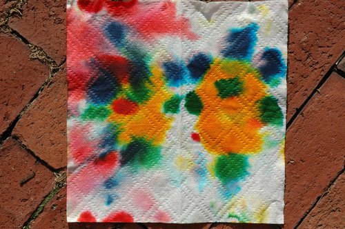 Food coloring on paper (photographed on brick path)
